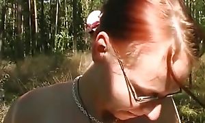 Amazing redhead with small tits masturbates her wet bawdy cleft with a dildo outdoors
