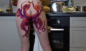 Naked housewife with octopus gabbing on tush cooks dinner on kitchen and ignores you