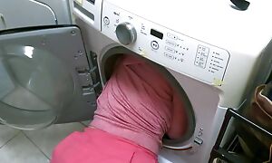 Stepmom stuck alongside the washing machine takes in the chips alongside both holes there evade in the chips a close-knit