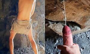Neanderthal man masturbates his penis in a cavern near a fire